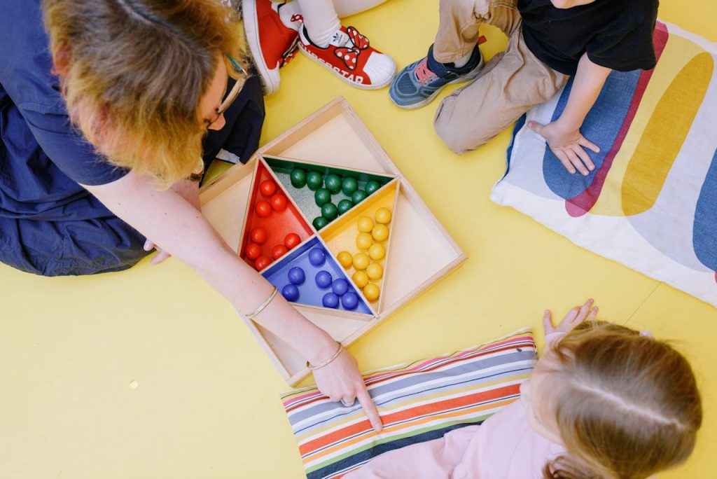 Children gathered around a colorful educational game in a classroom setting, enhancing learning.